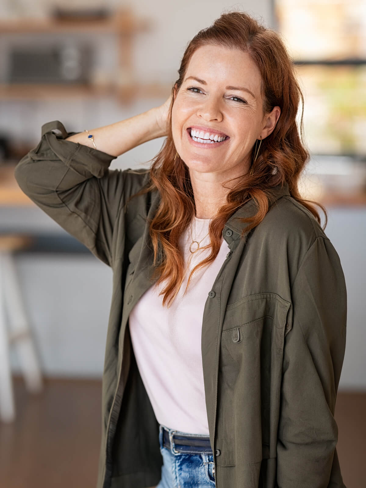 Laughing woman running a hand through her hair