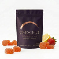 Strawberry Lemonade creatine gummies pouch with fresh strawberries and lemon